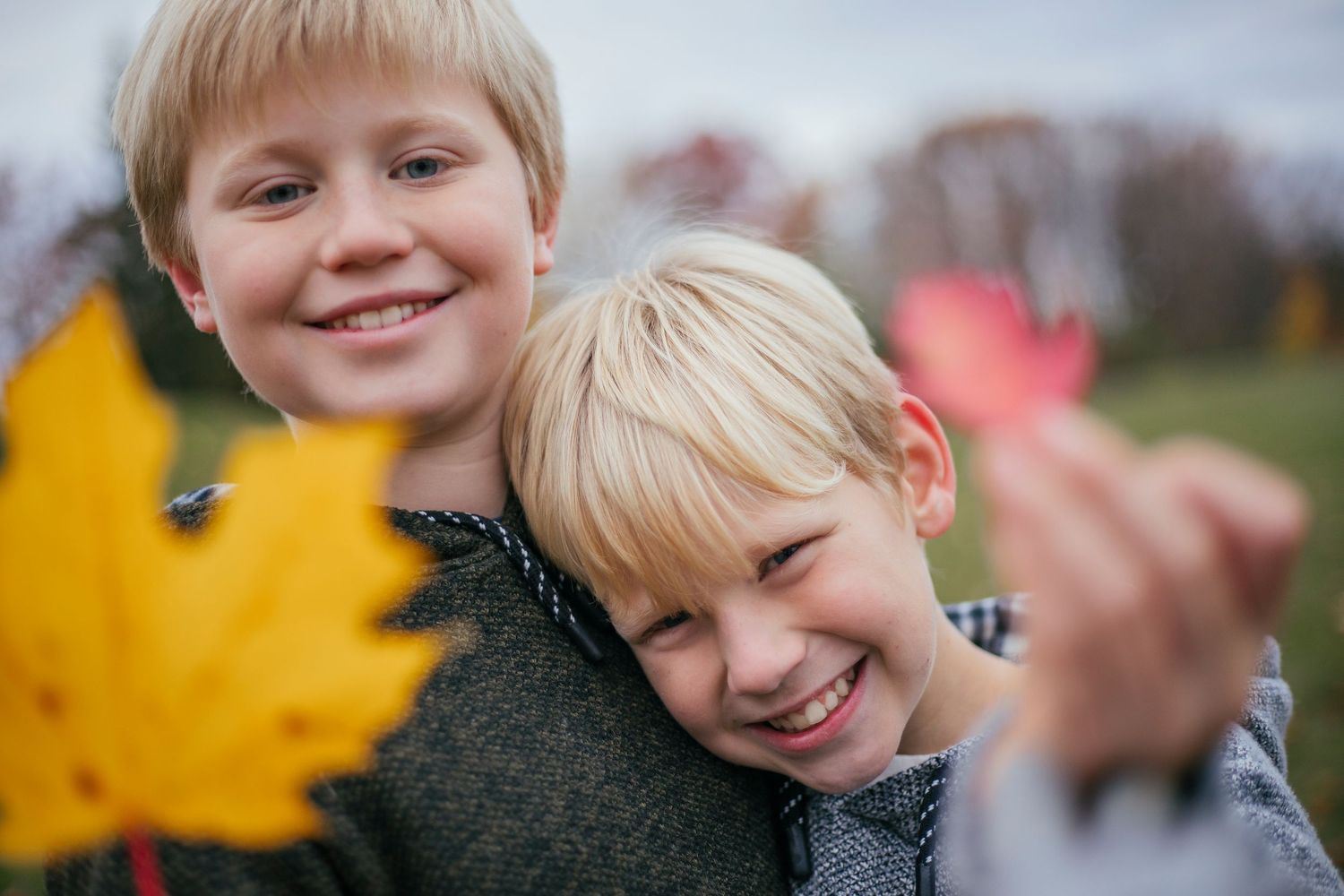 Brothers sharing a playful moment during an outdoor photography session in Île-Perrot
