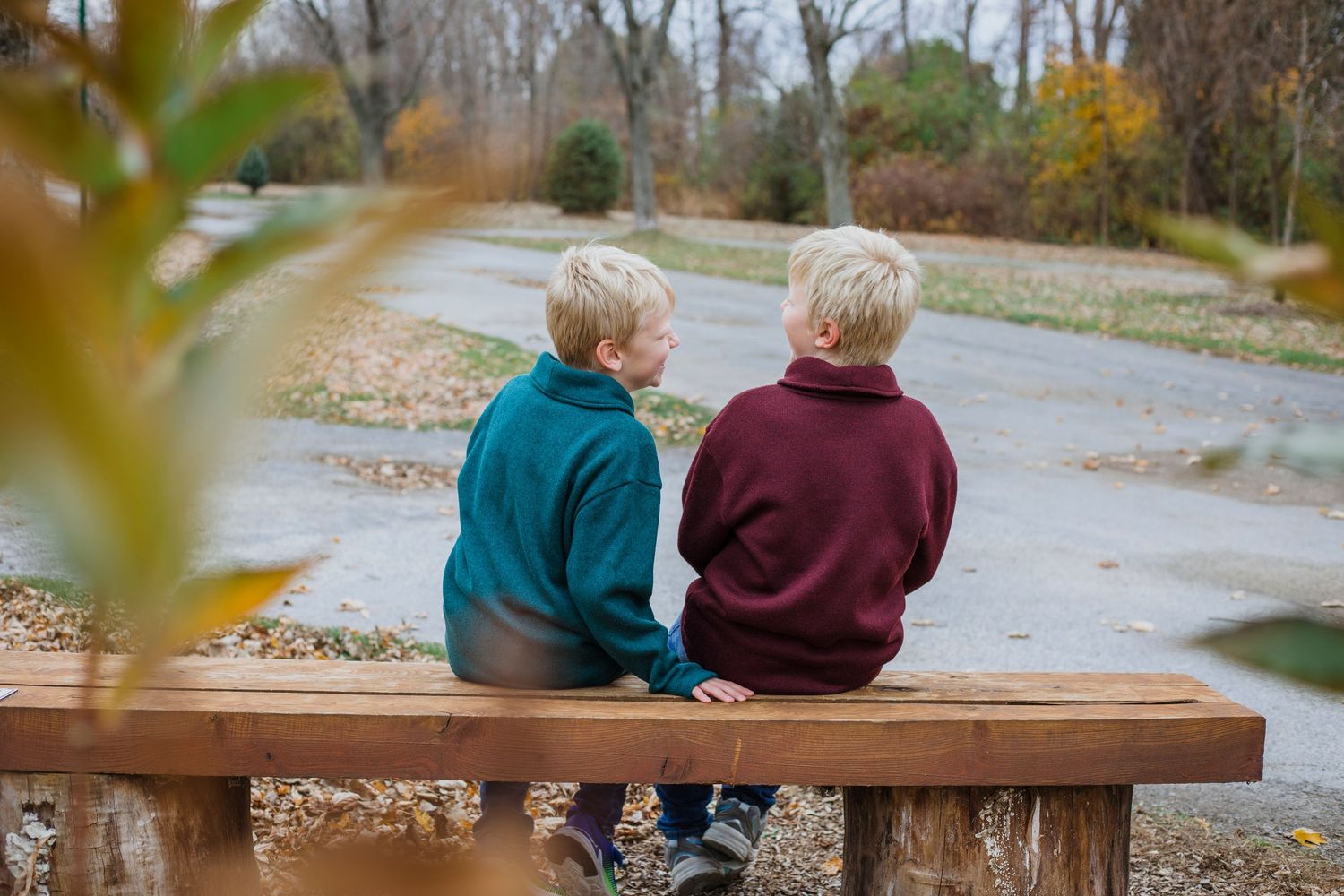 Brothers sharing a playful moment during an outdoor photography session in Île-Perrot