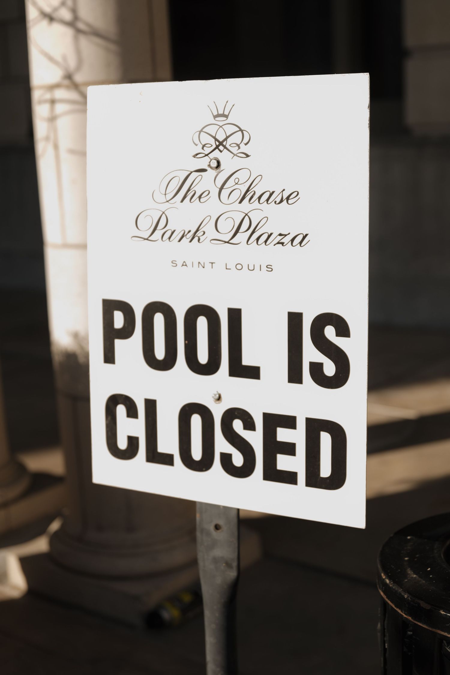 The Chase Park Plaza Saint Louis hotel sign announcing pool is closed on sunny day.