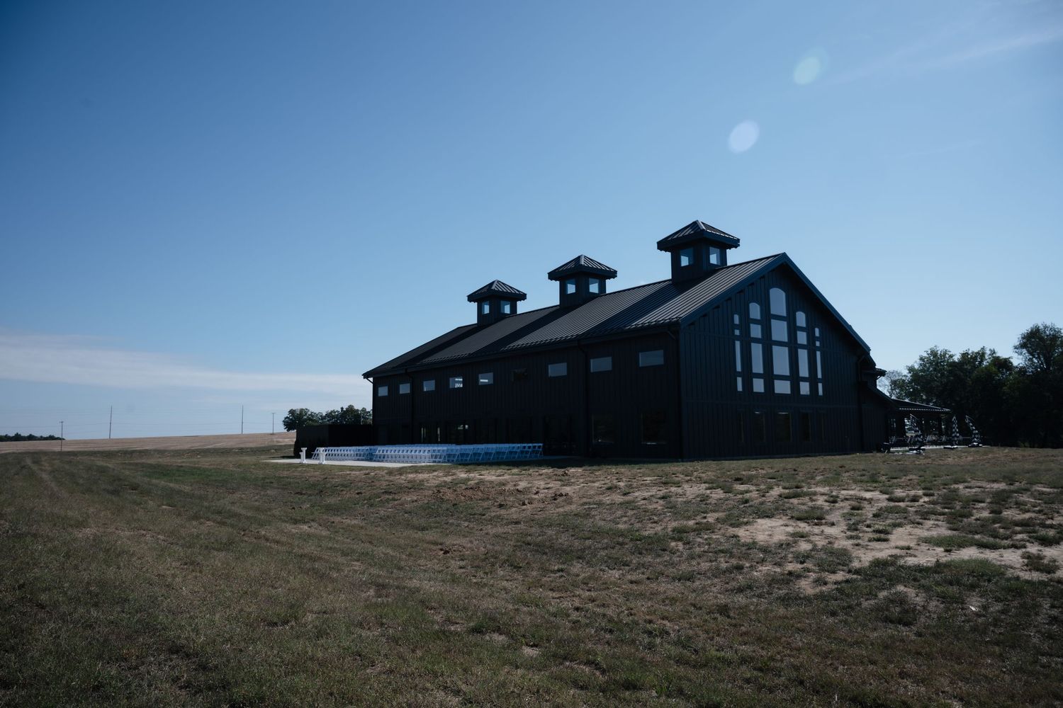 A series of panoramic photos showing a modern coastal building with dark roof against blue sky and sandy beach landscape.