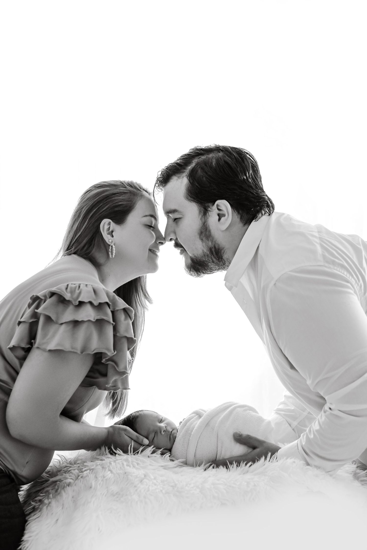 Black and white intimate family portrait captured in natural light.