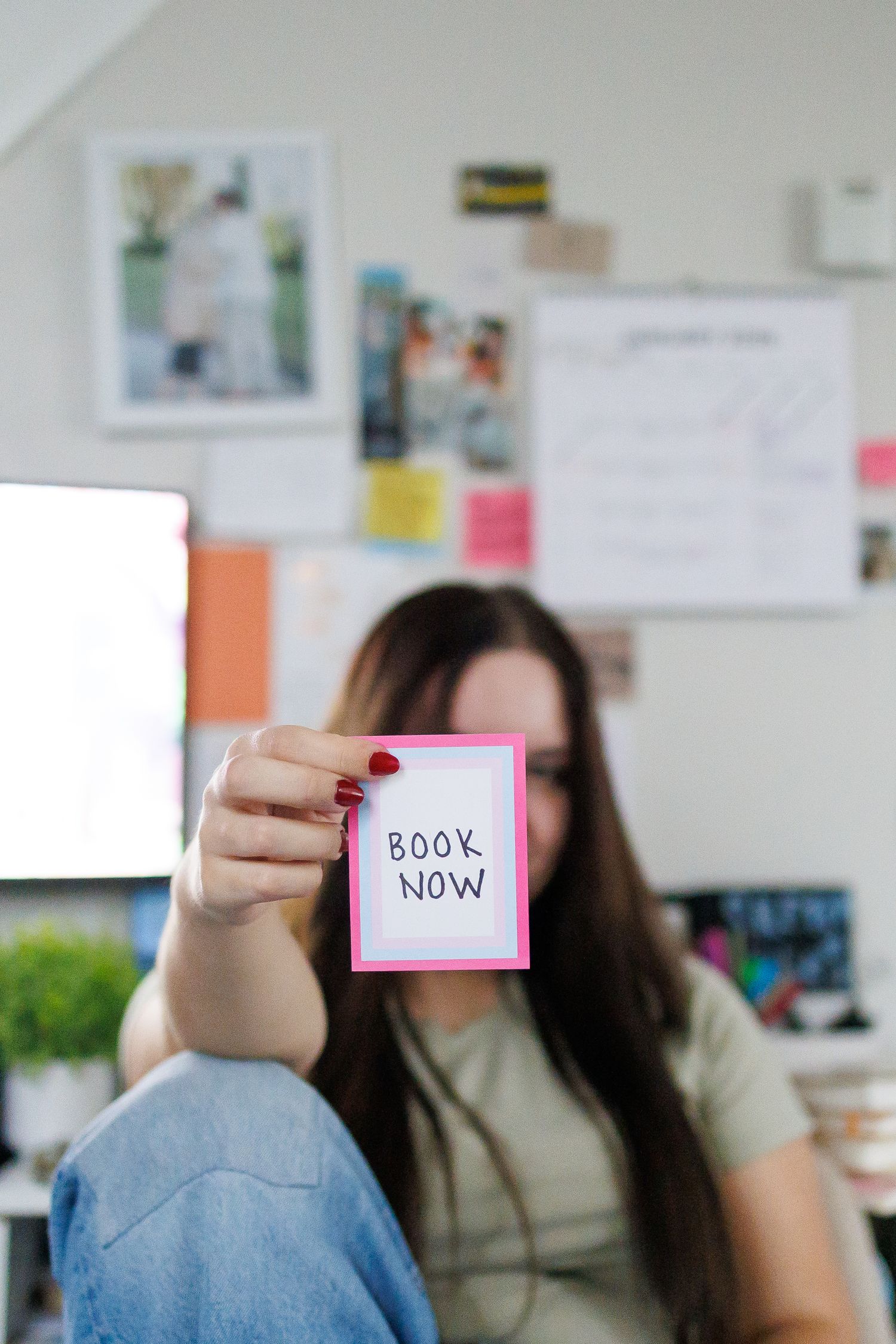 A sequence of images showing hands holding pink sticky notes or cards in an office setting.