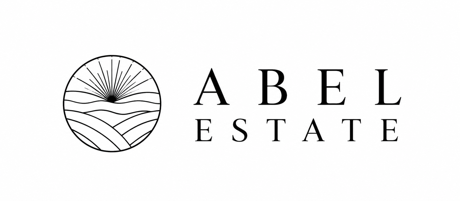 Abel Estate logo featuring a circular emblem with sun rays and rolling hills above elegant spaced serif typography.