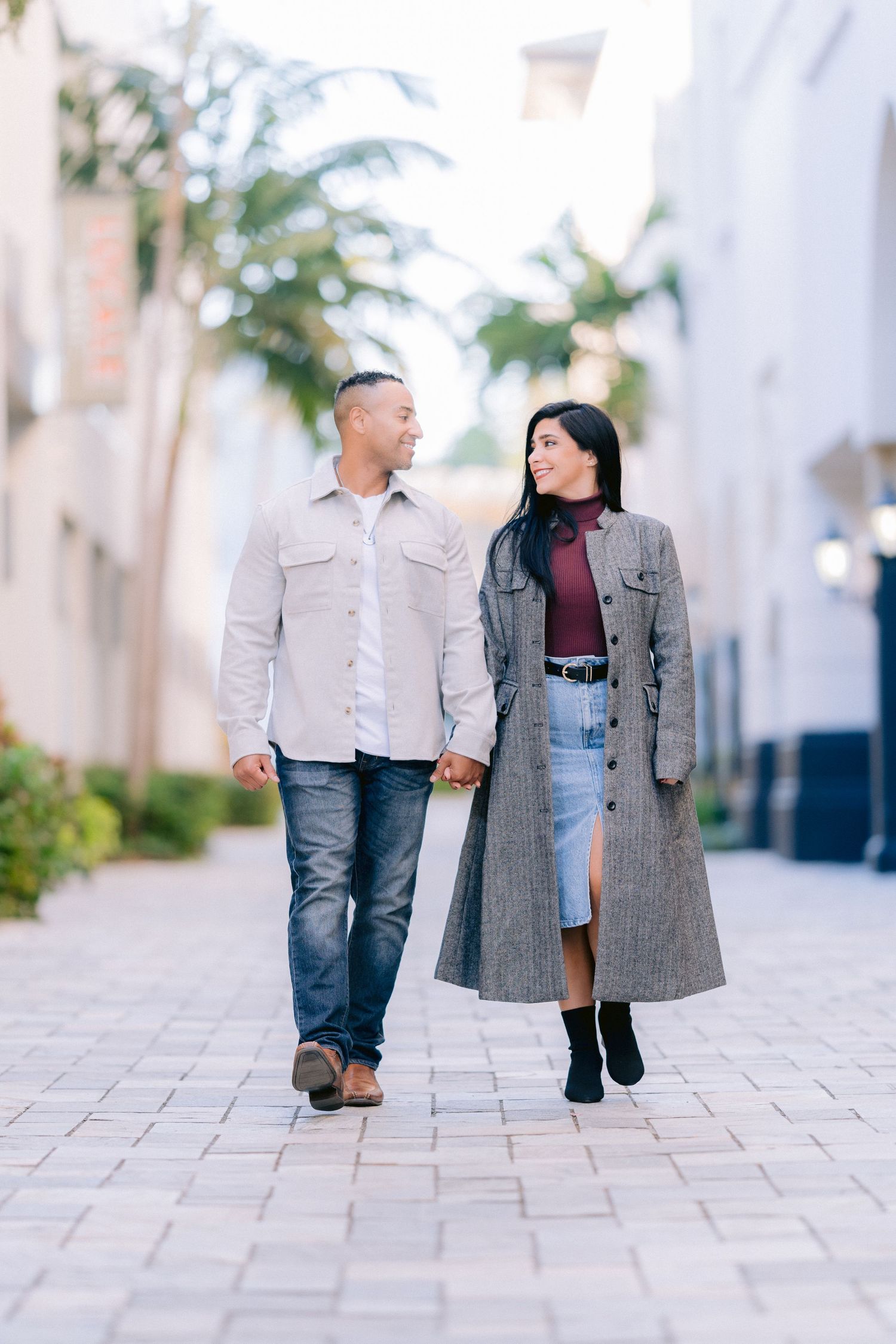A couple walks together holding hands in St Pete, Florida, Photo from engagement session