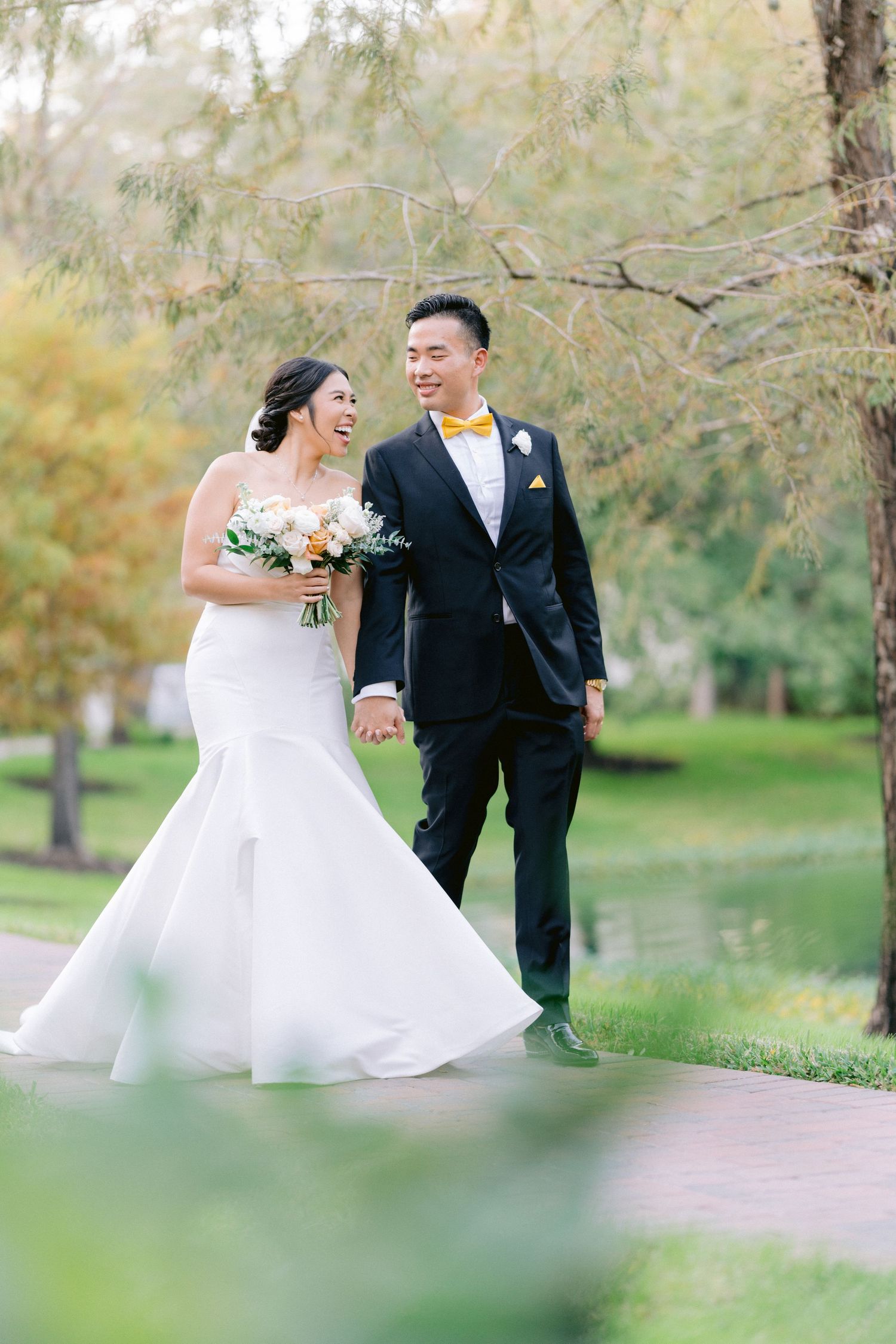 Newlyweds share joyful moments together in a romantic outdoor garden setting with soft natural lighting. Tampa Bay Wedding Photographer