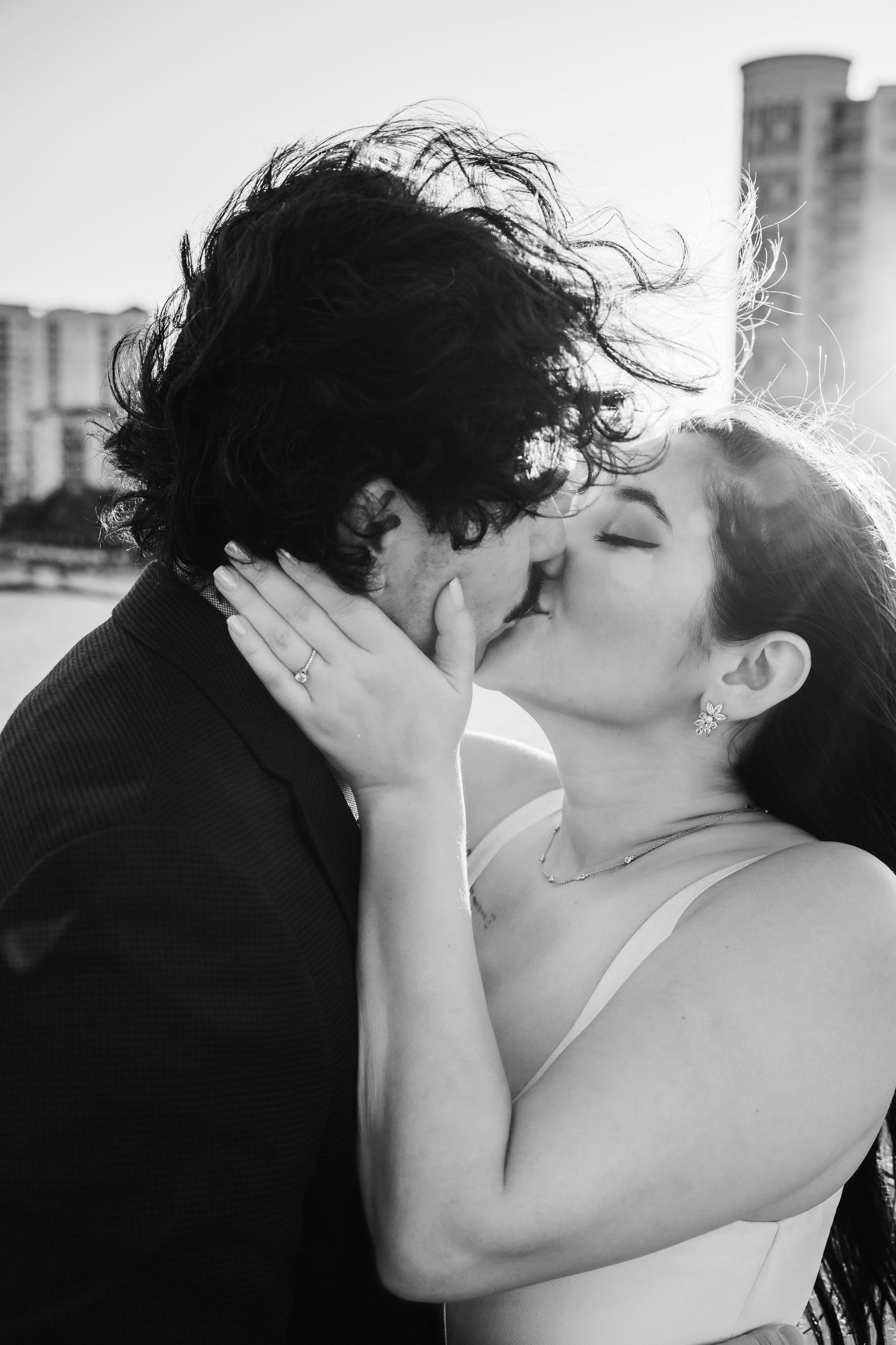 A romantic black and white photo sequence showing a couple sharing a passionate kiss in increasing close-up views.