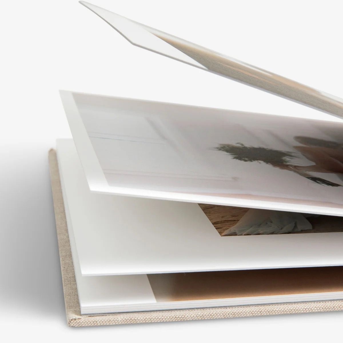 Close-up view of layered white photo album pages with textured edges.