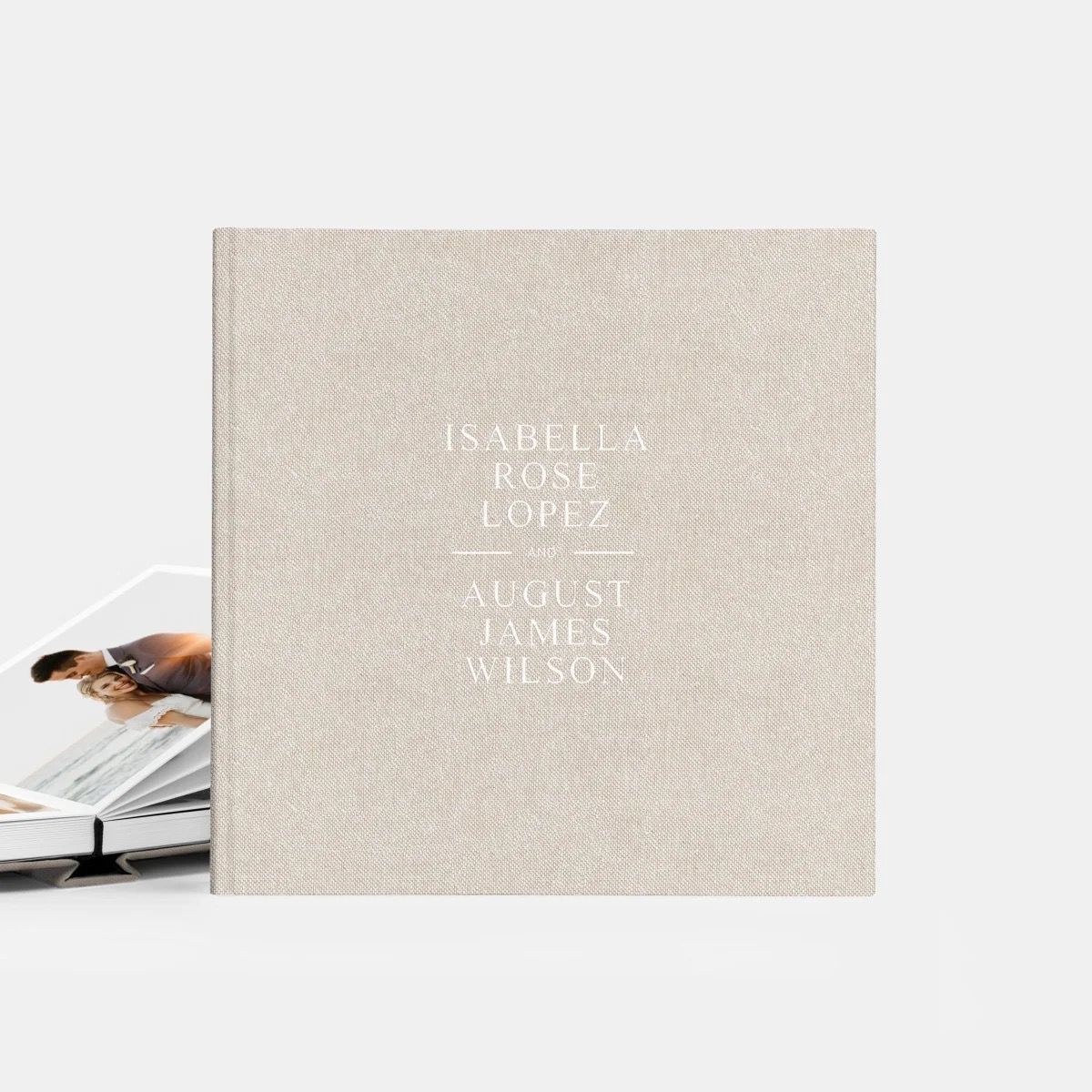Minimalist photo album cover design with text on natural linen fabric.