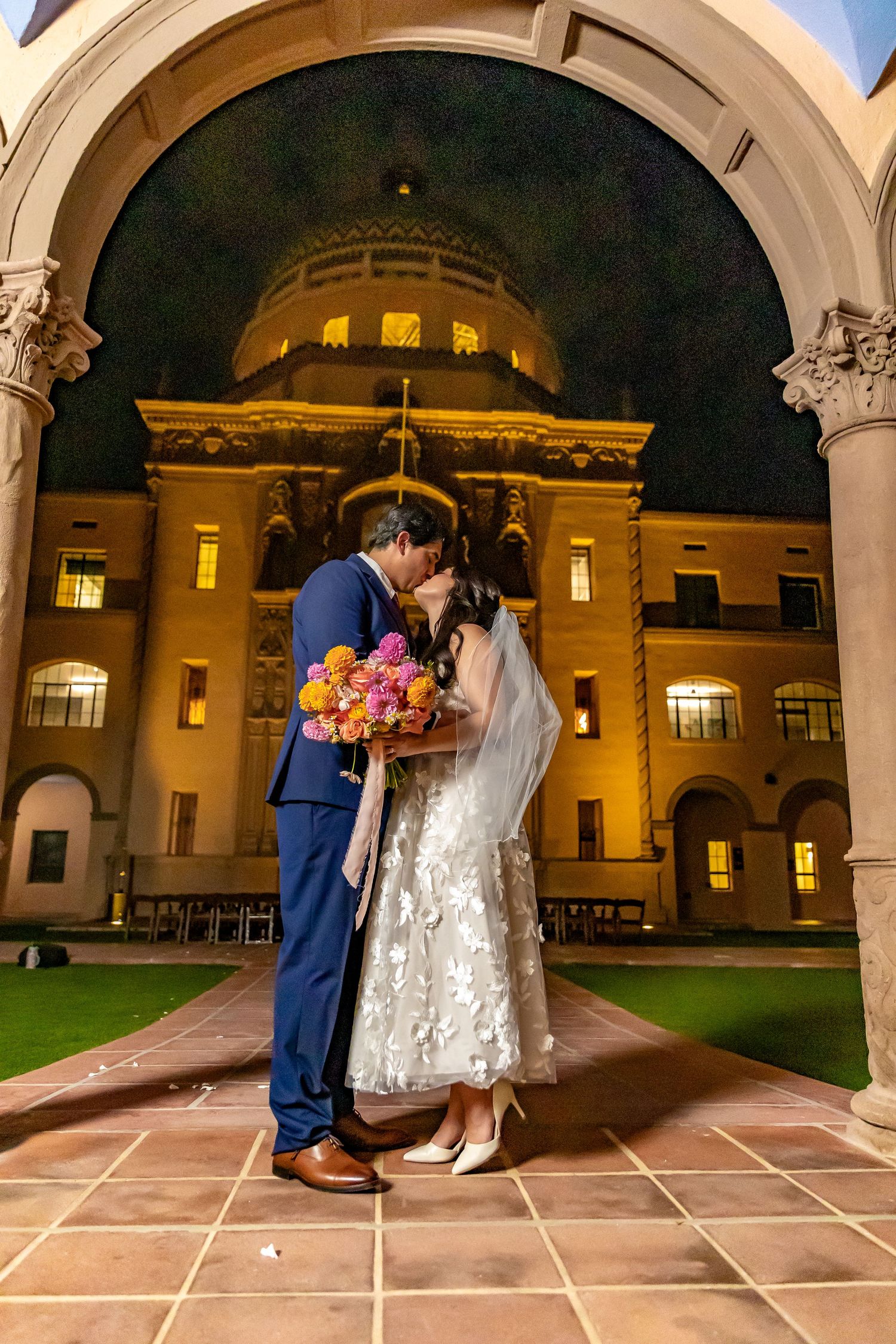 Newlywed couple kissing at the Historic Pima County Courthouse