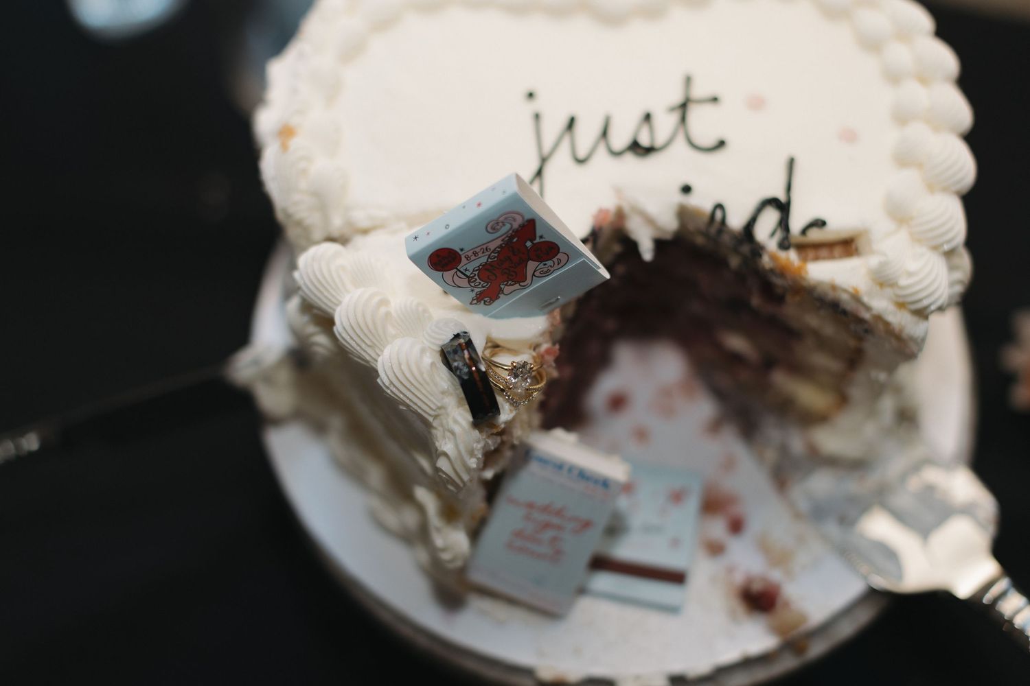 A partially cut white wedding cake with 