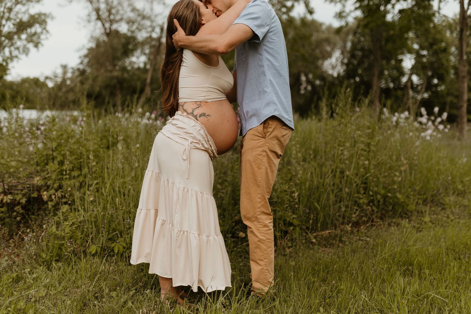 A romantic couple's portrait session in a rustic outdoor setting with soft natural lighting.