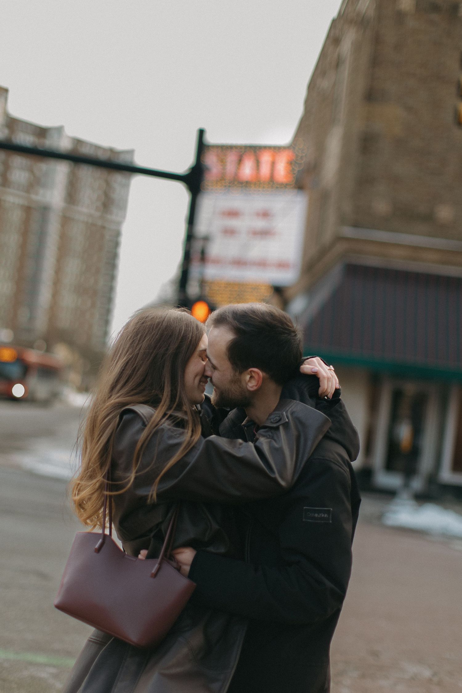 A couple sharing an intimate moment in an urban setting.