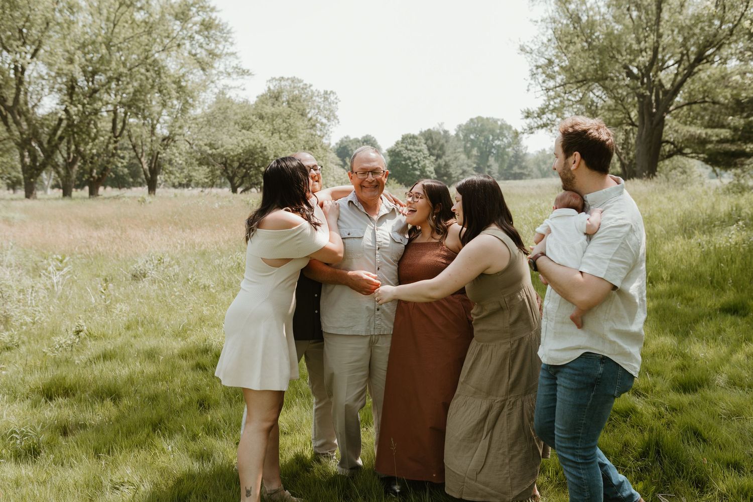 Casual family gathering with playful interactions in a natural outdoor setting.
