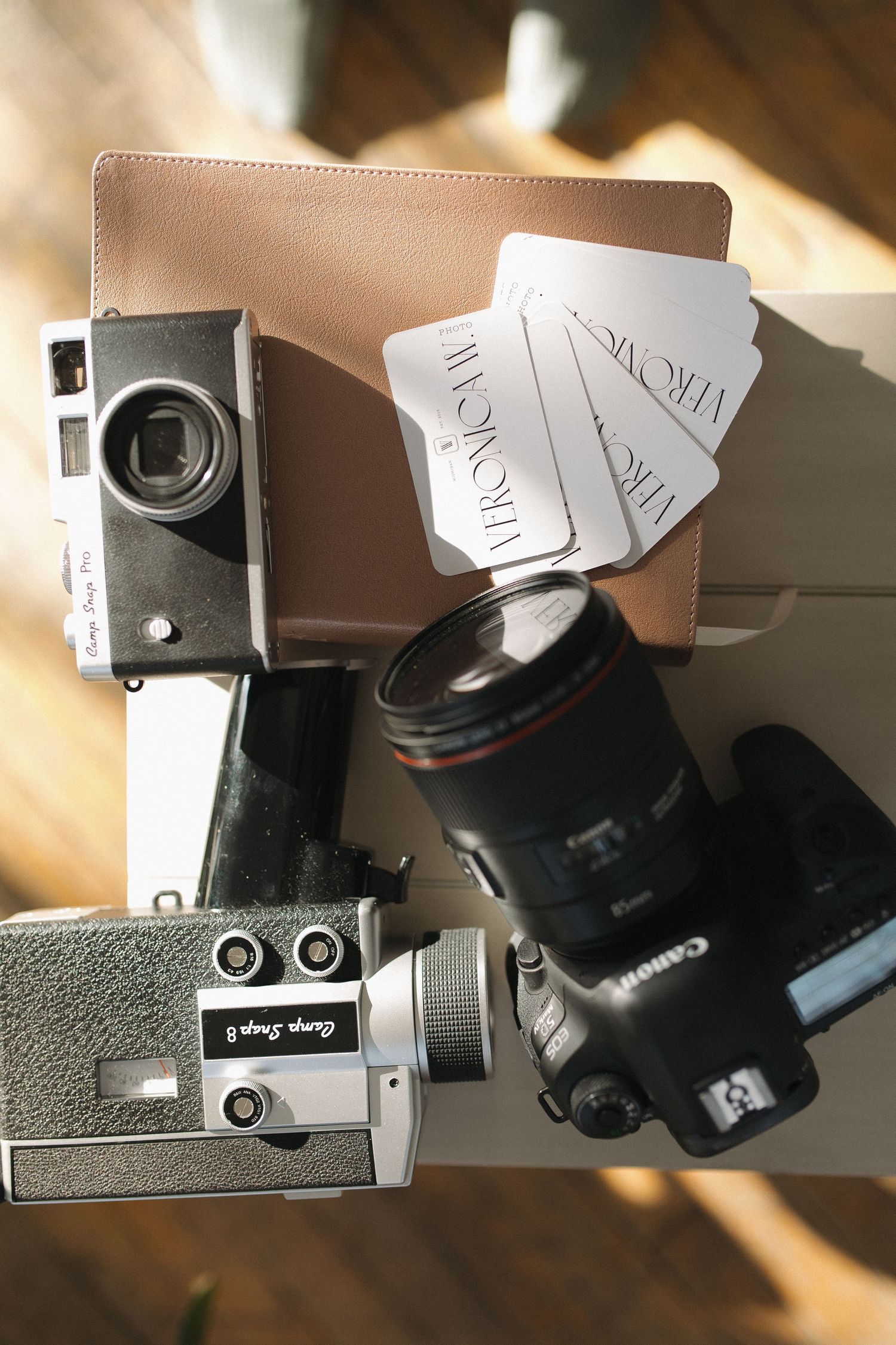 Vintage film camera with manual focus controls and lens shown in multiple detail shots.