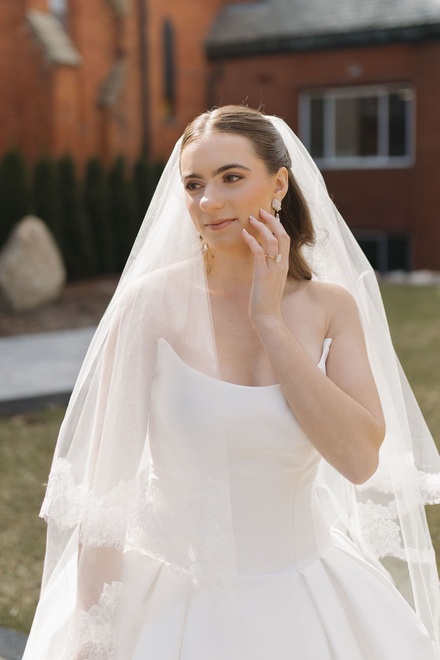 Elegant bridal portraits featuring classic white wedding dress and flowing veil.