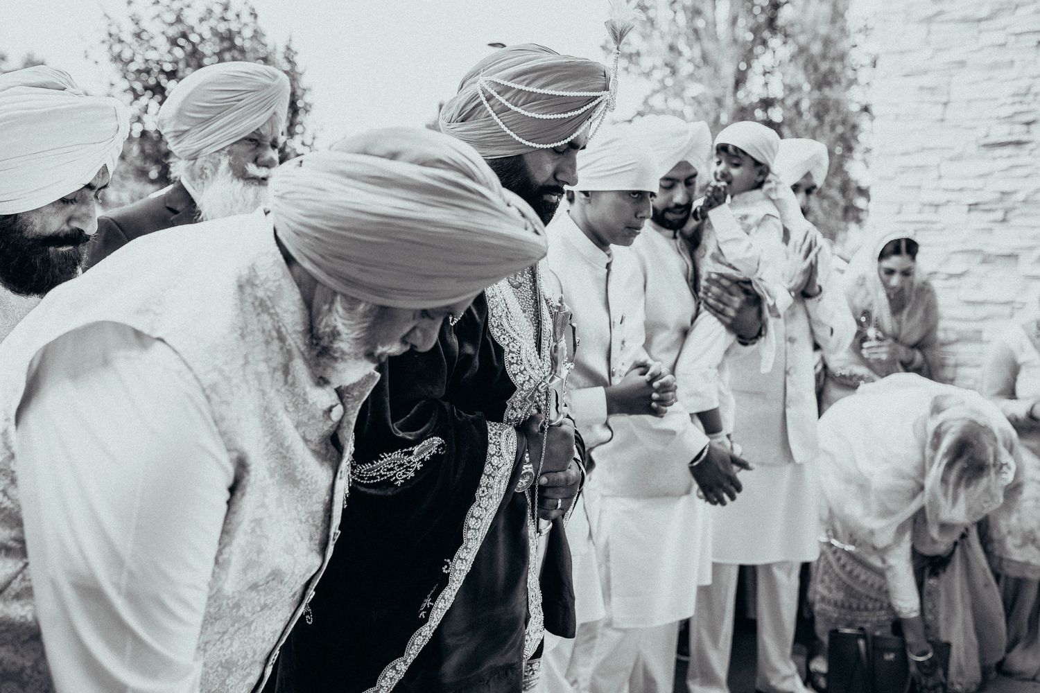 A black and white photograph showing participants in traditional ceremonies and cultural dress.