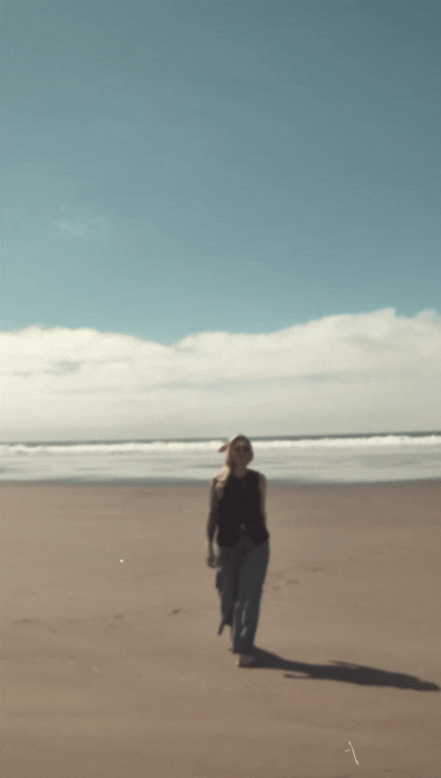 Woman walks on beach