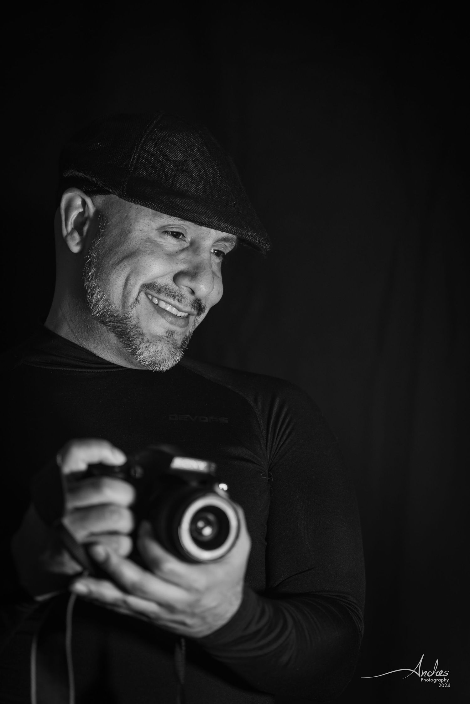 Black and white portrait of professional photographer Andres capturing a moment