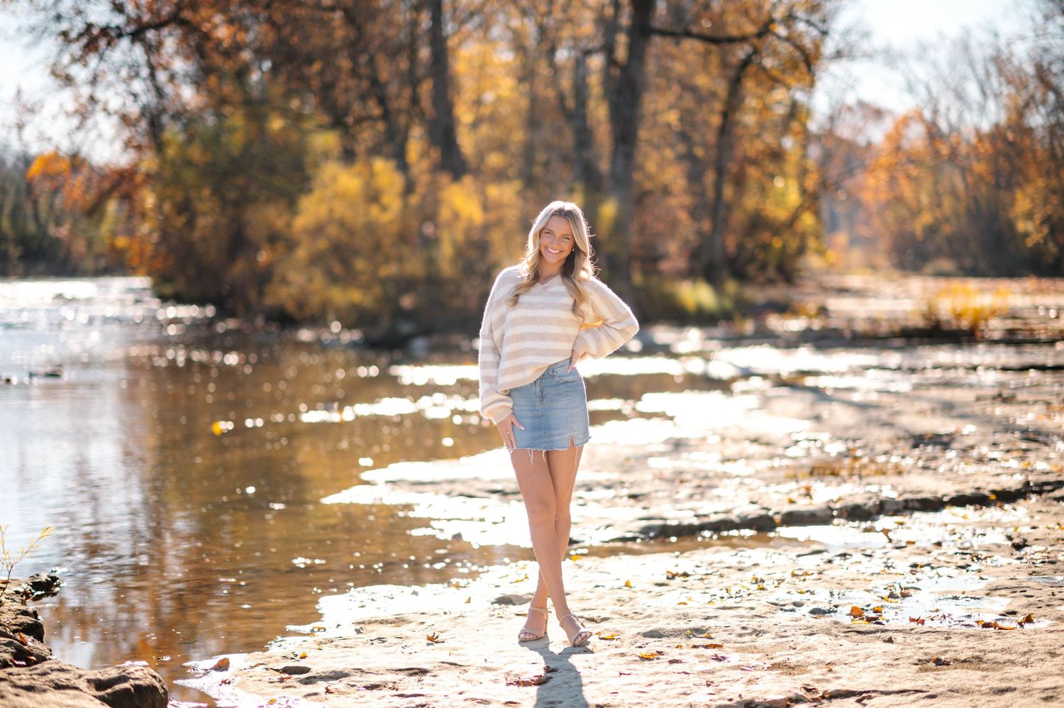 Autumn riverside portrait with fall foliage and sunlight.