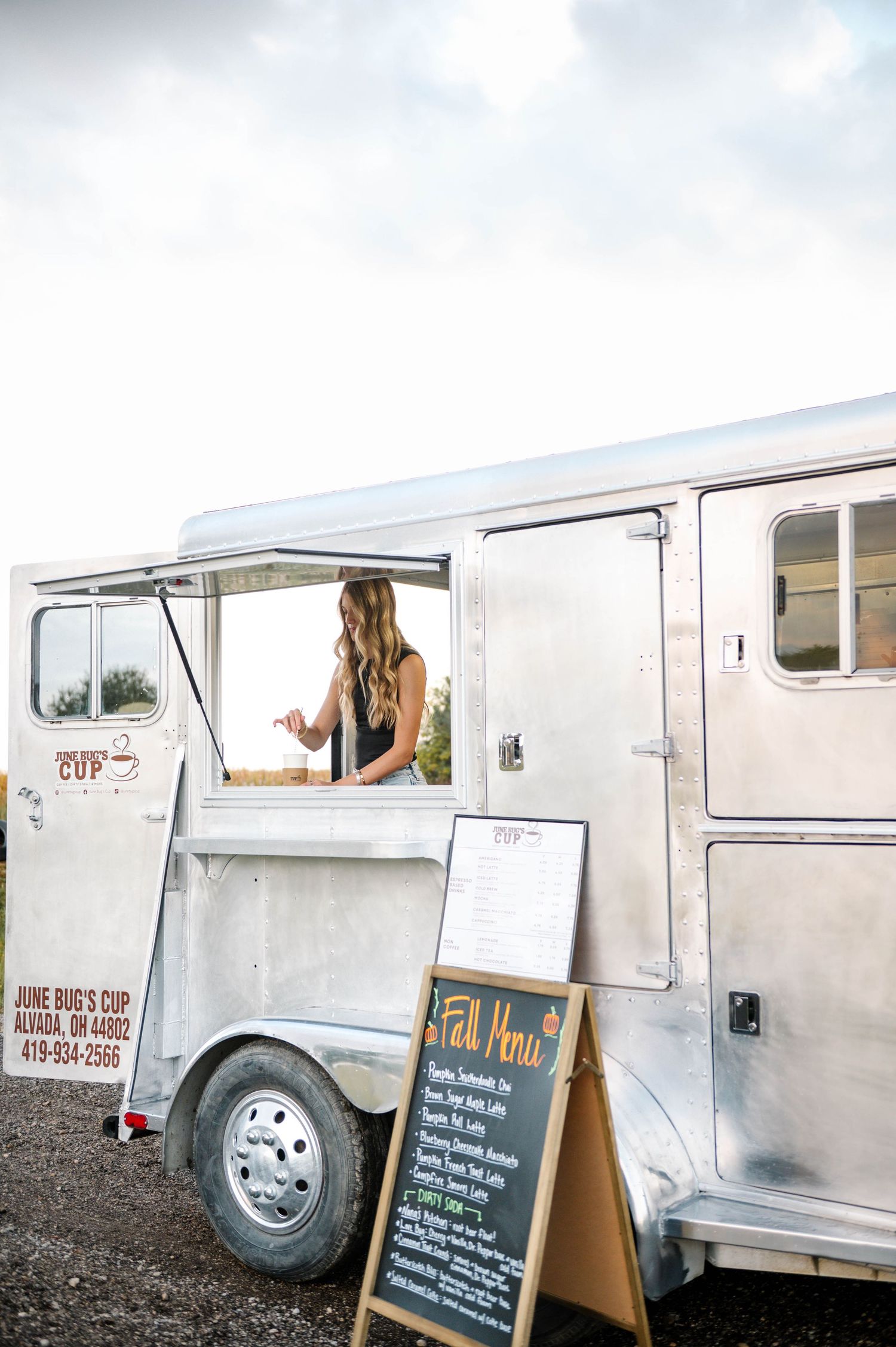 Mobile coffee truck exterior showing service window and business signage.