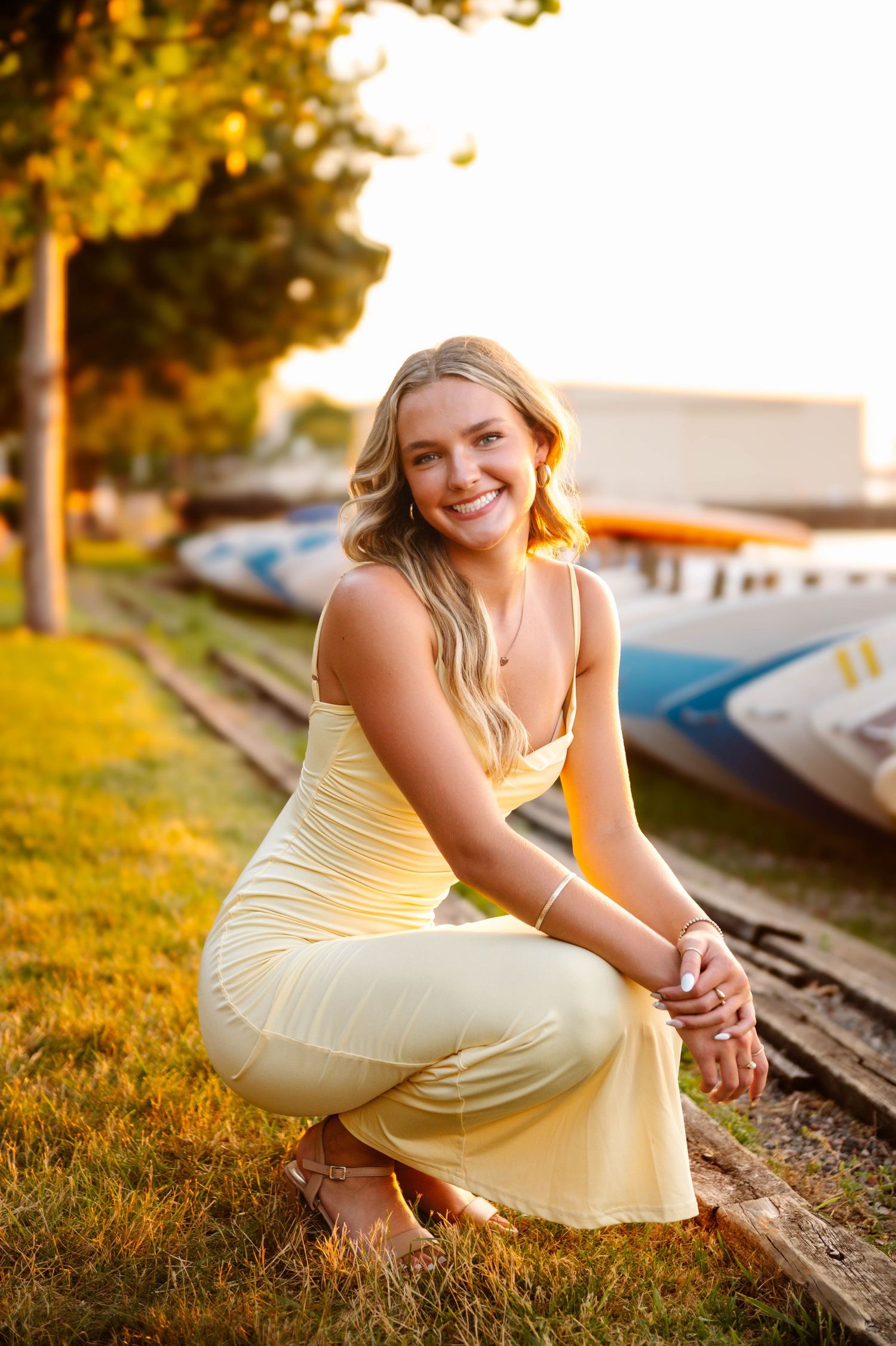 A yellow sundress glows warmly in golden hour light during an outdoor portrait session.