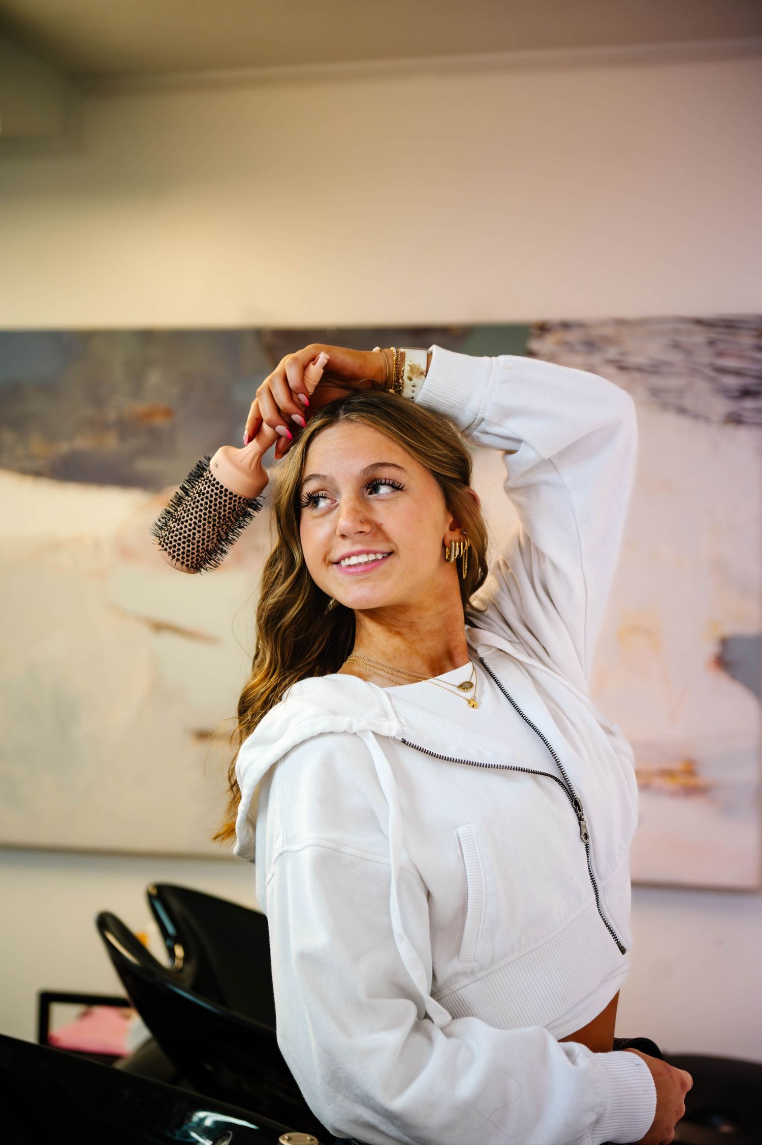 Professional photoshoot featuring a white button-down shirt and natural lighting in a modern studio setting.