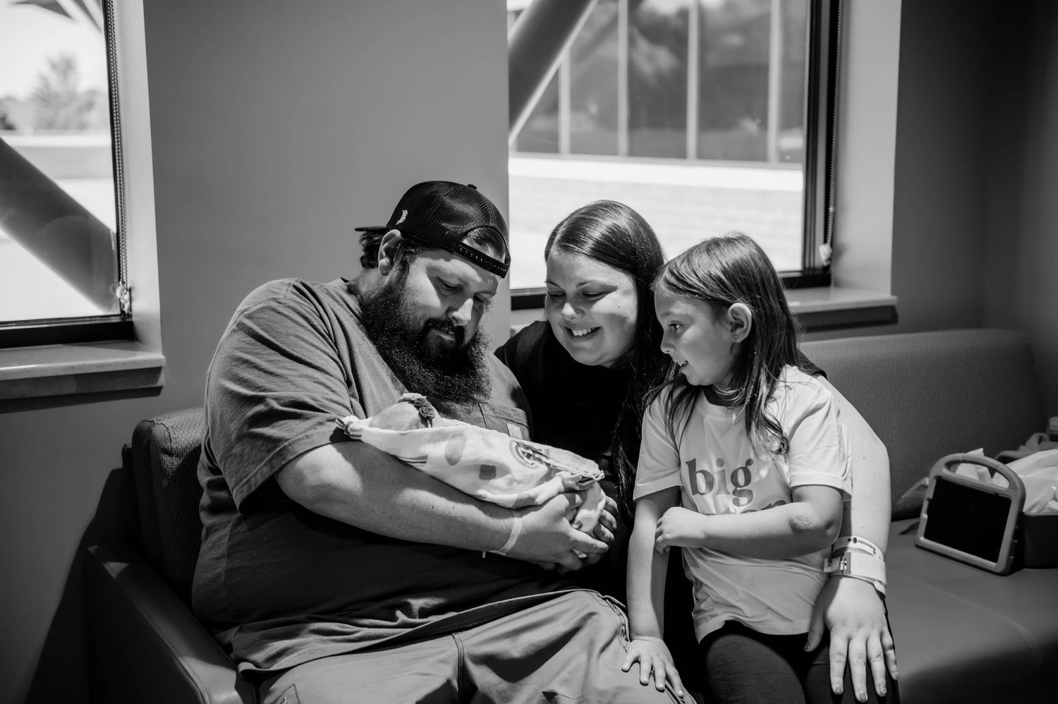 Family members share emotional moments together in a hospital setting.