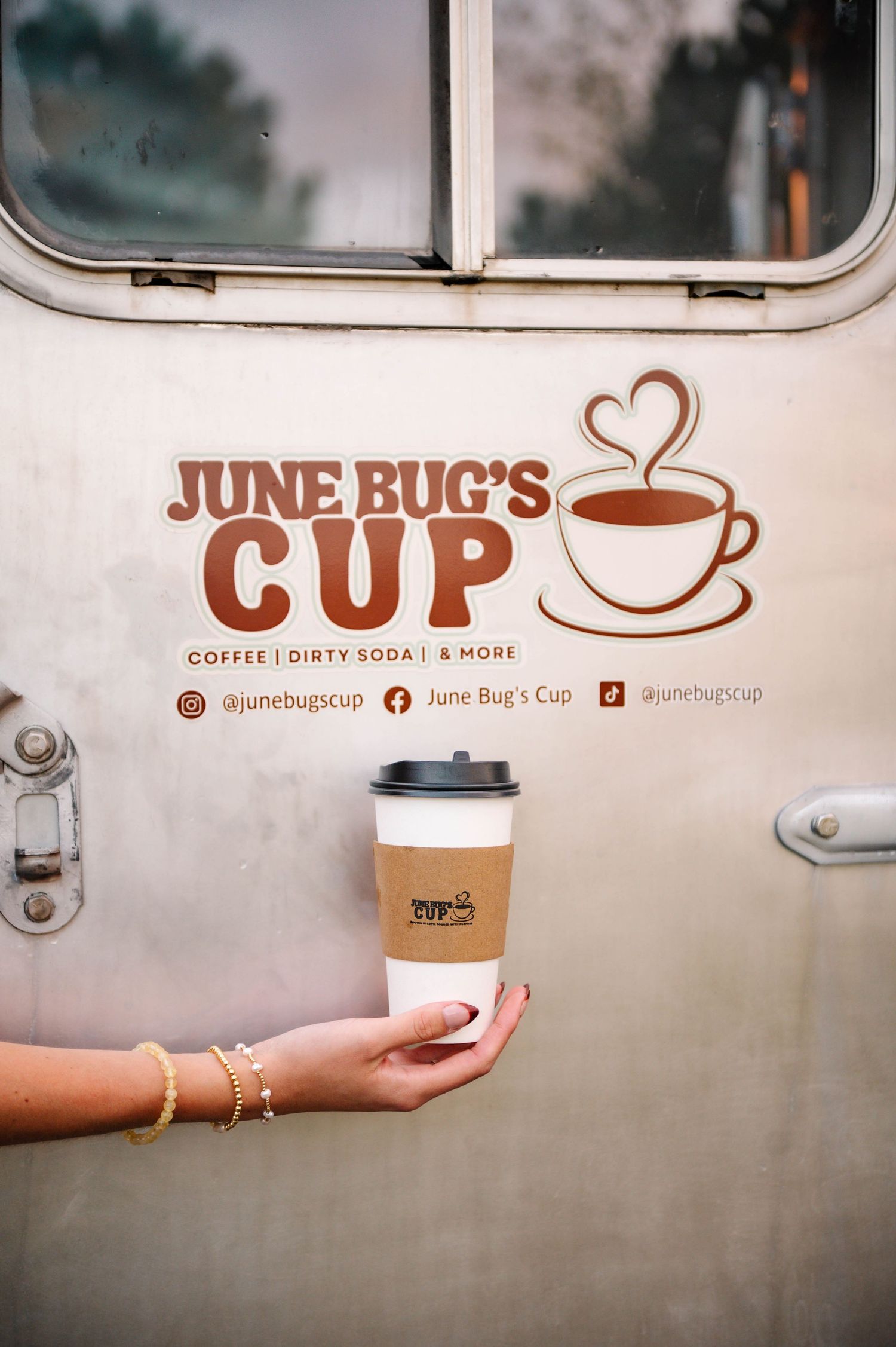 June Bug's Cup coffee truck branding and logo displayed on white service vehicle.