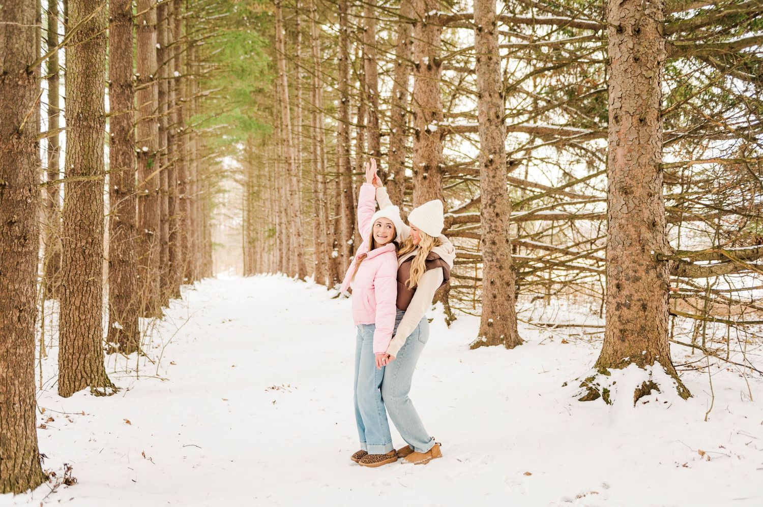 A winter scene in a pine forest with people enjoying the snowy landscape.