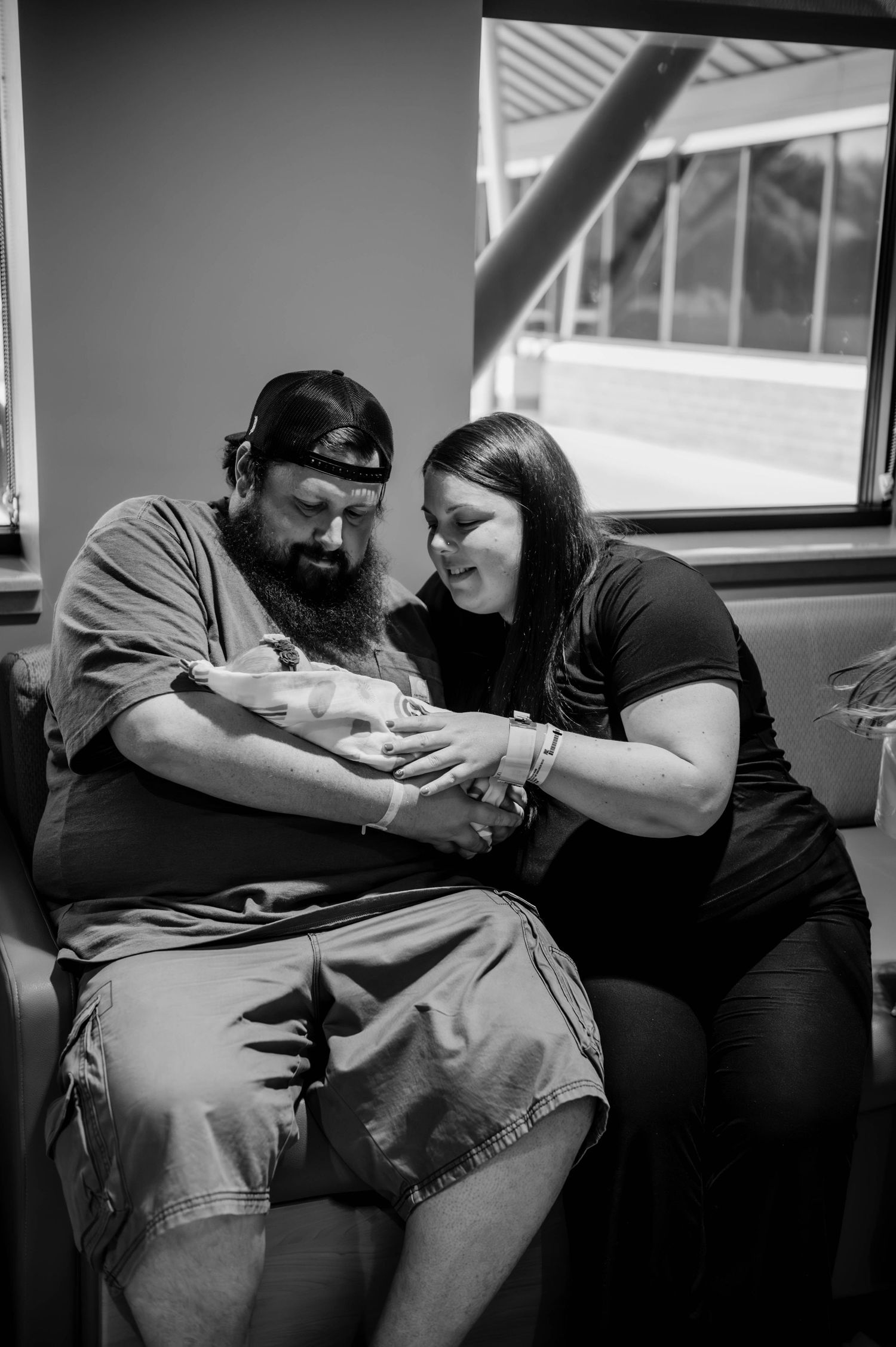 A touching family moment as they sit together in a hospital room.