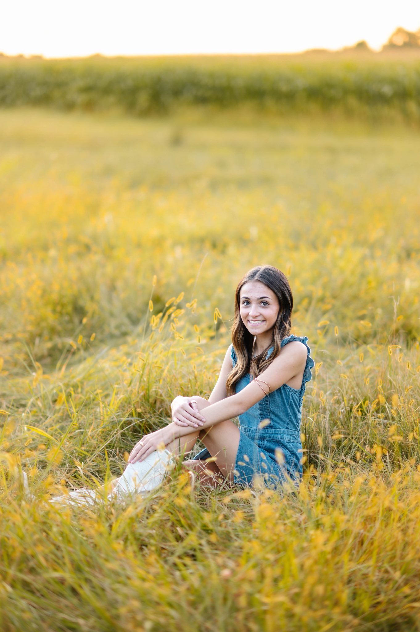 A casual summer portrait session in a golden field during sunset.