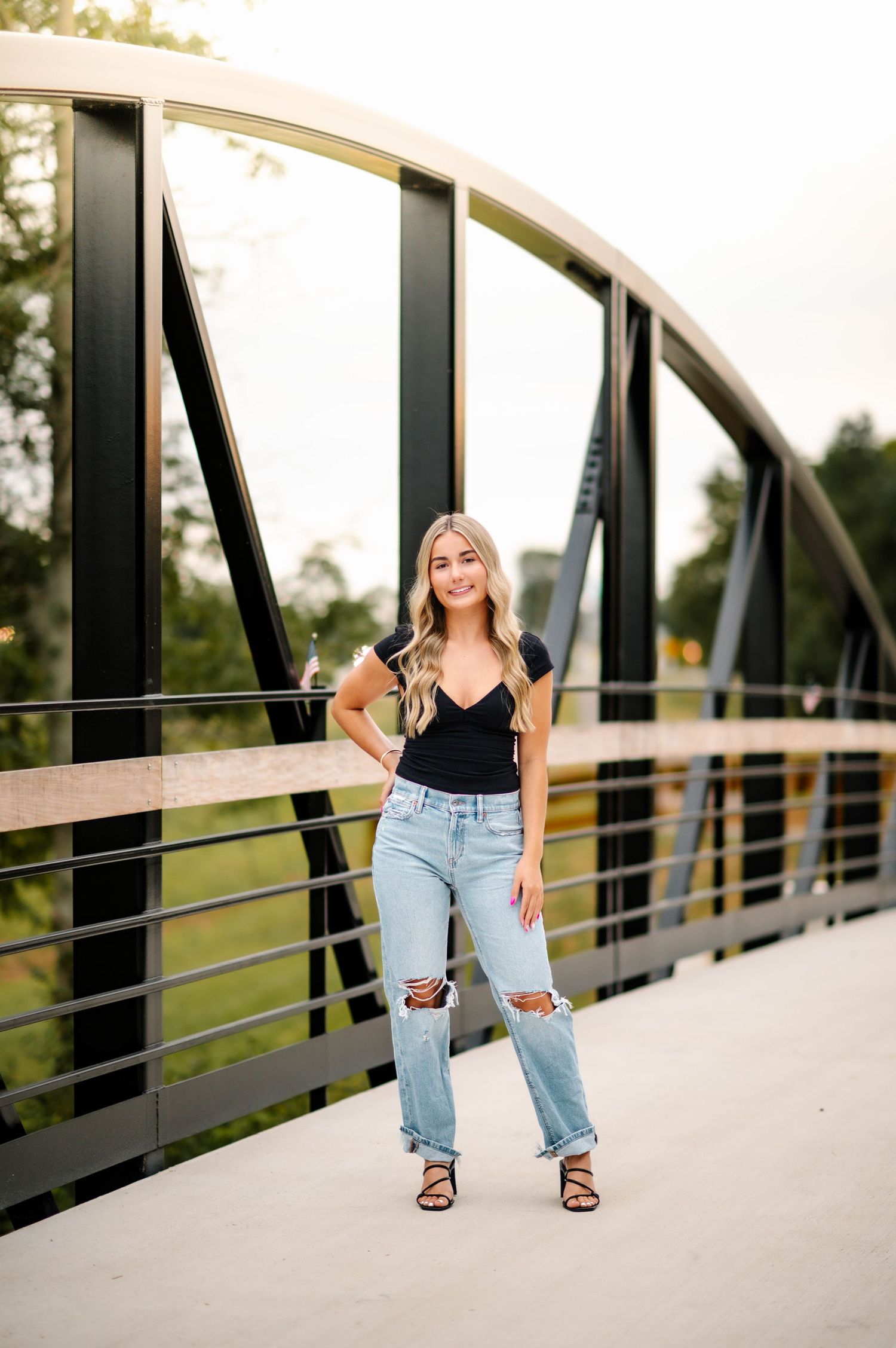 Modern architectural photoshoot on a metal bridge with clean geometric lines.