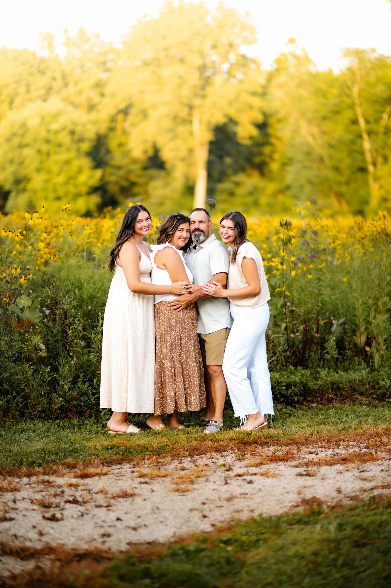 People share joyful moments together in a field of wildflowers during golden hour.