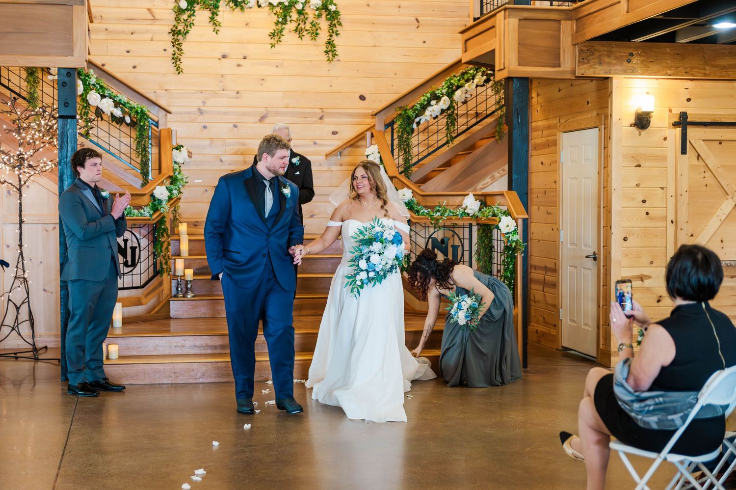 Wedding celebration inside a wooden lodge with warm lighting and rustic decor.