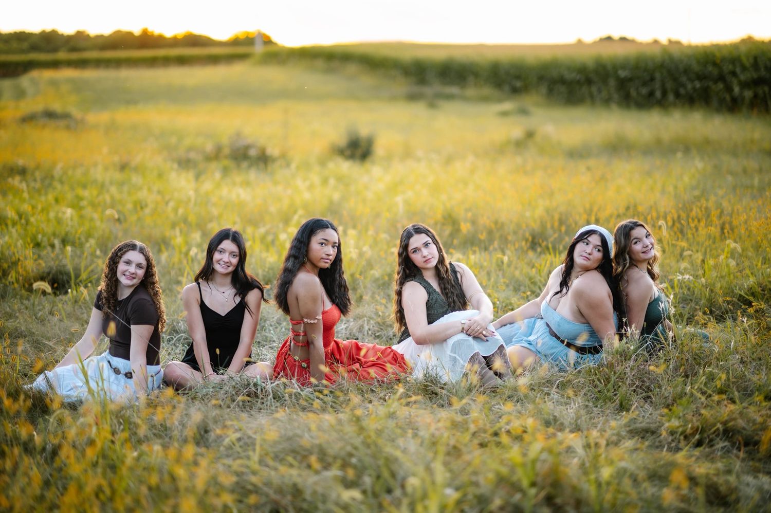 Friends relax together in a wildflower field during golden hour.