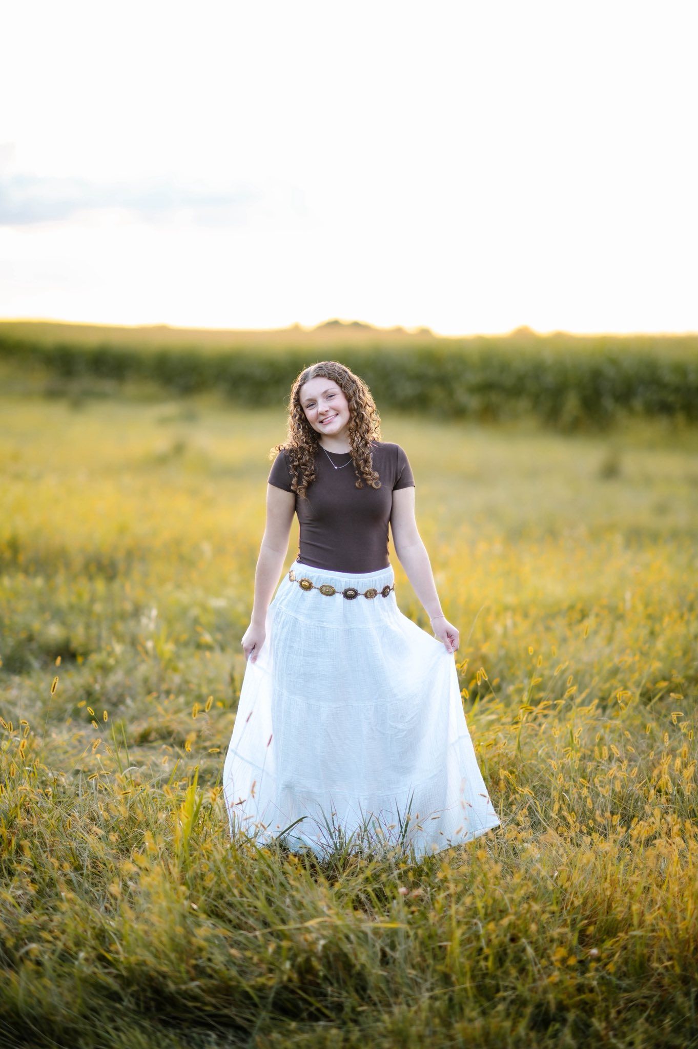 A white tulle skirt twirls in a summer meadow during golden hour.
