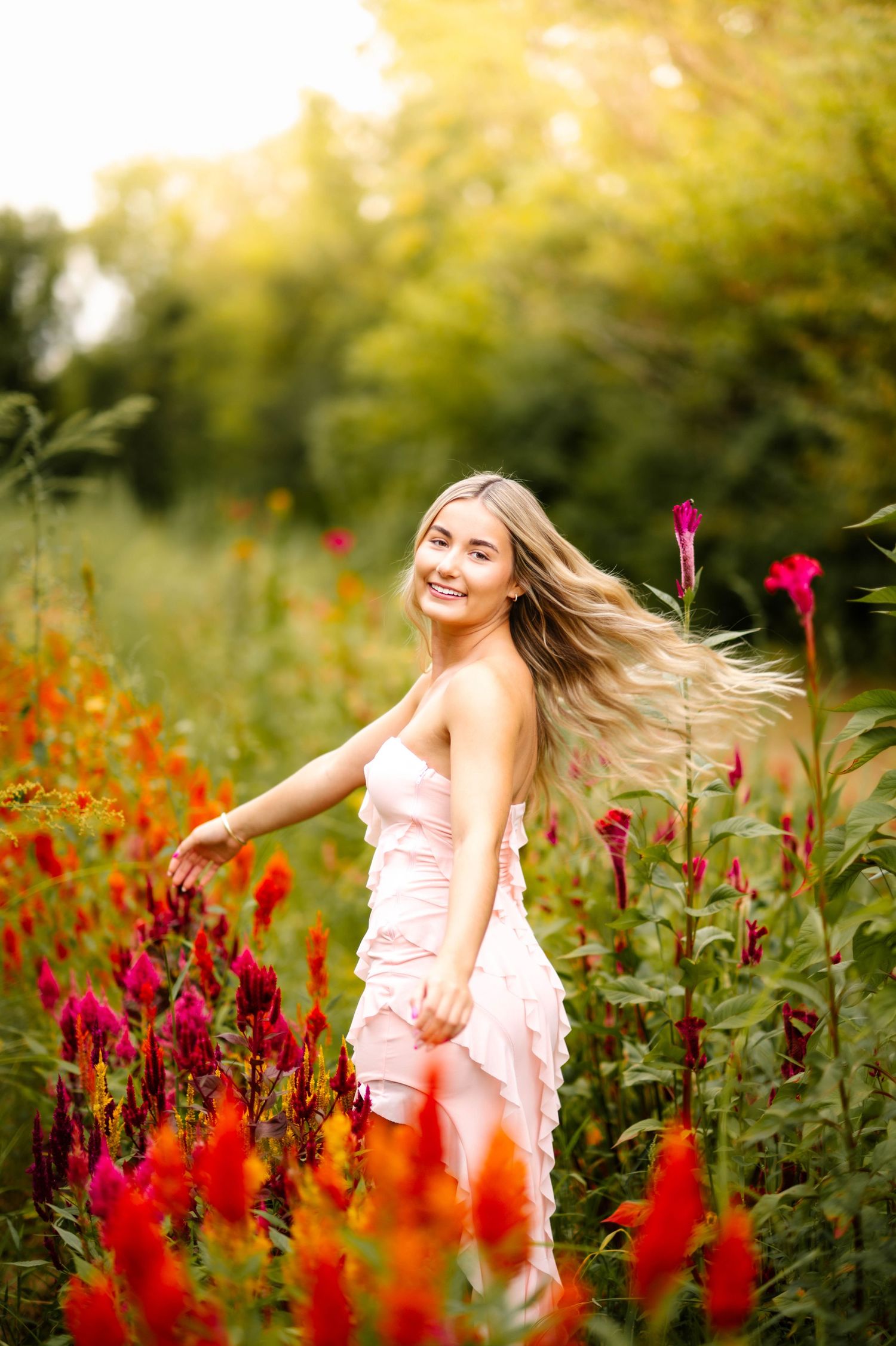 Joyful movement captured in a garden setting with red flowers and warm evening light.
