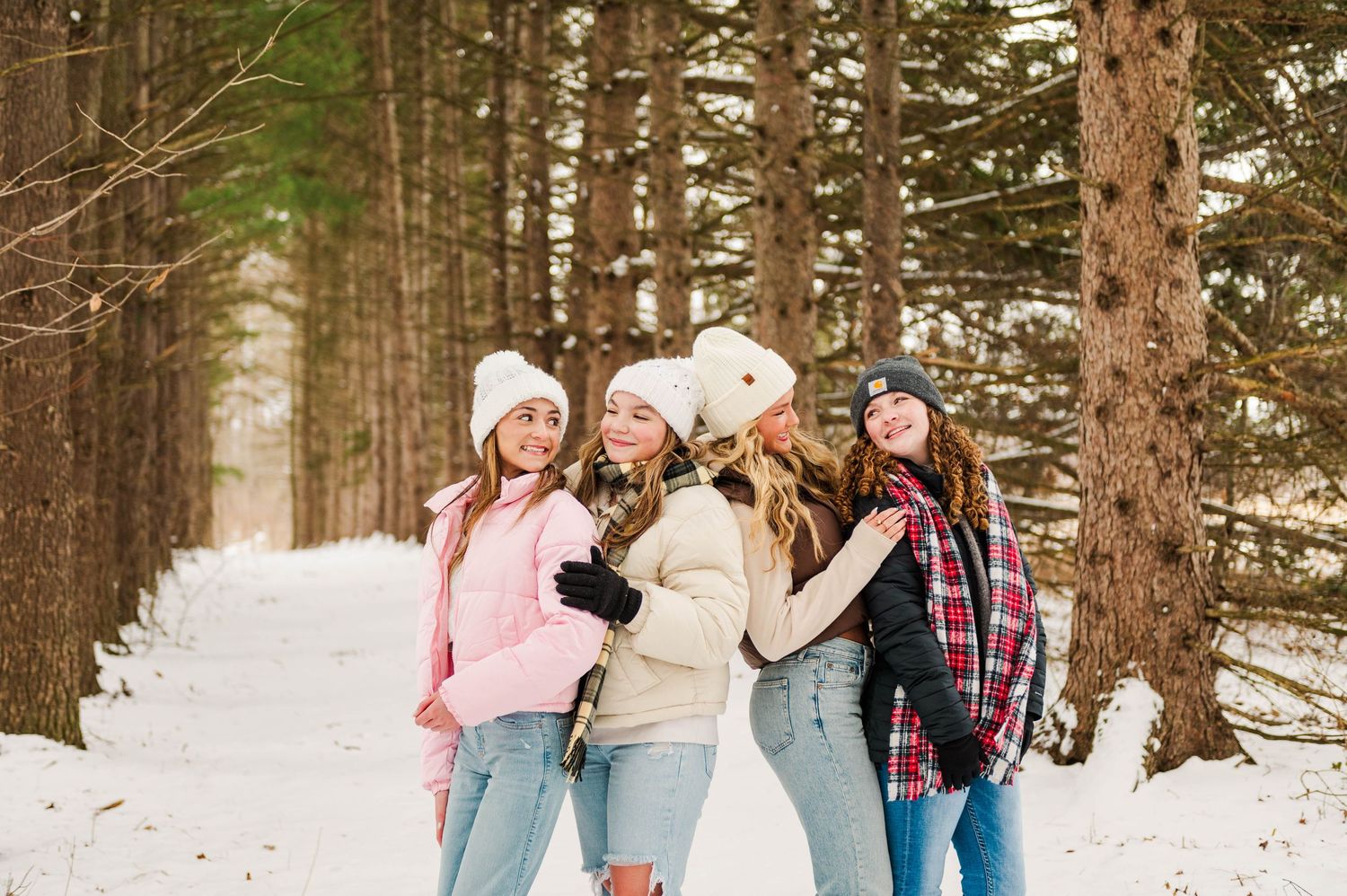 Group enjoying winter fun together in snowy forest setting.
