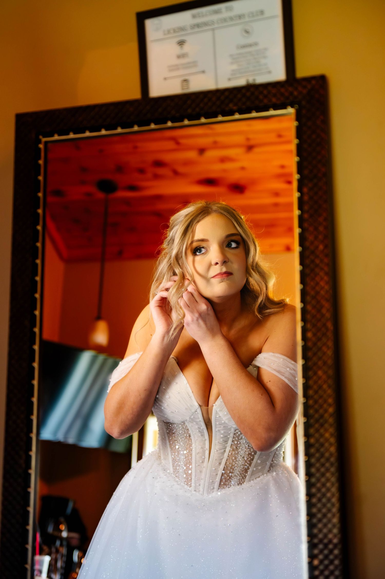 Close-up shots of white wedding dress details in warm lighting.