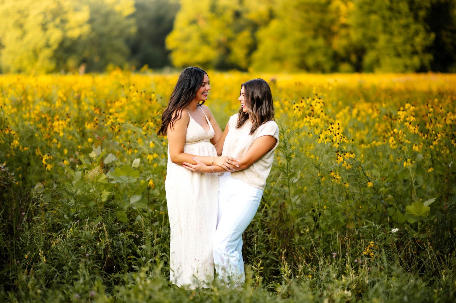 Candid moments captured between people in a sunny wildflower field during sunset.