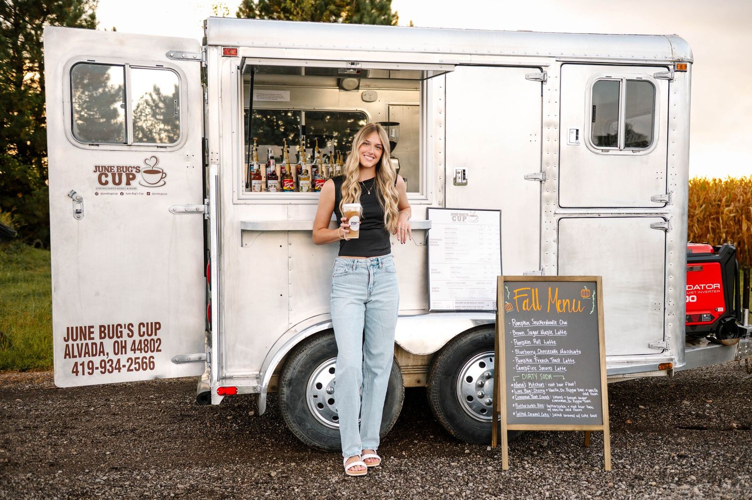White coffee food truck parked outdoors with service window and menu board visible.