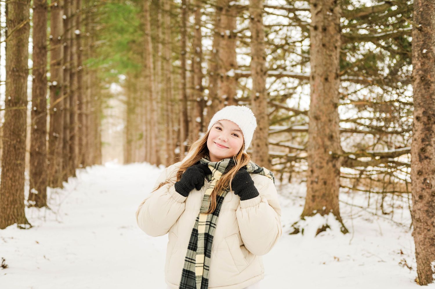 Winter forest scene with someone enjoying the snowy landscape.