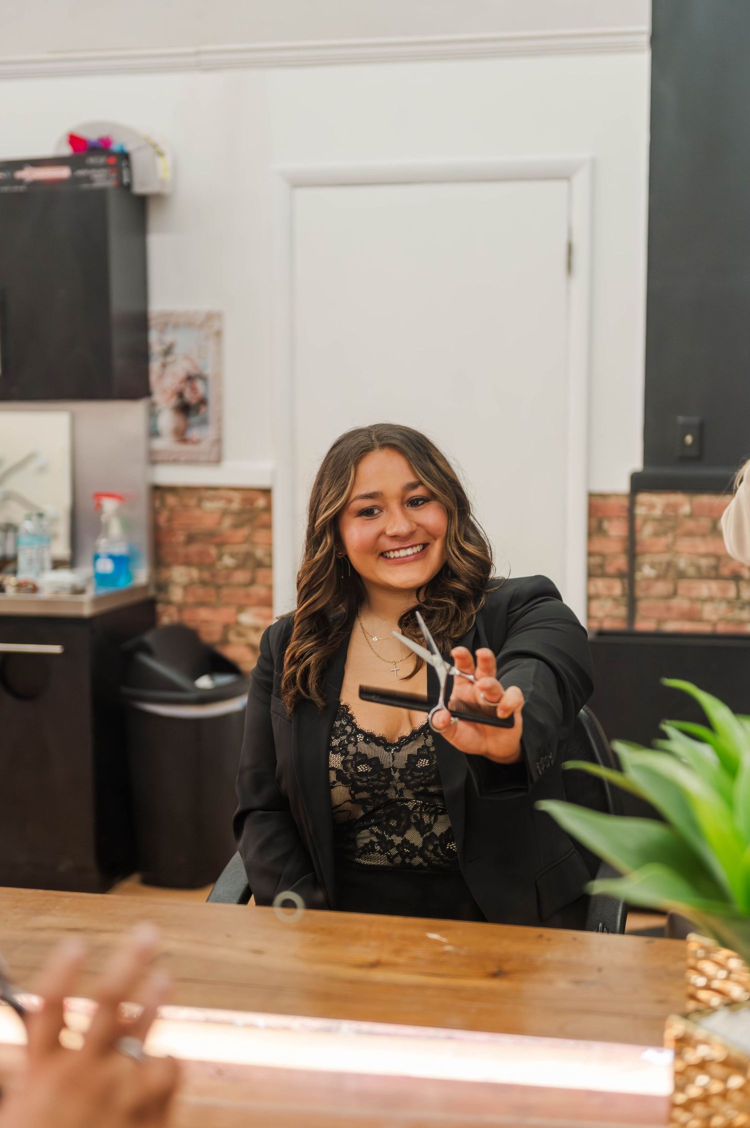 Professional business setting with wooden table and exposed brick wall interior.