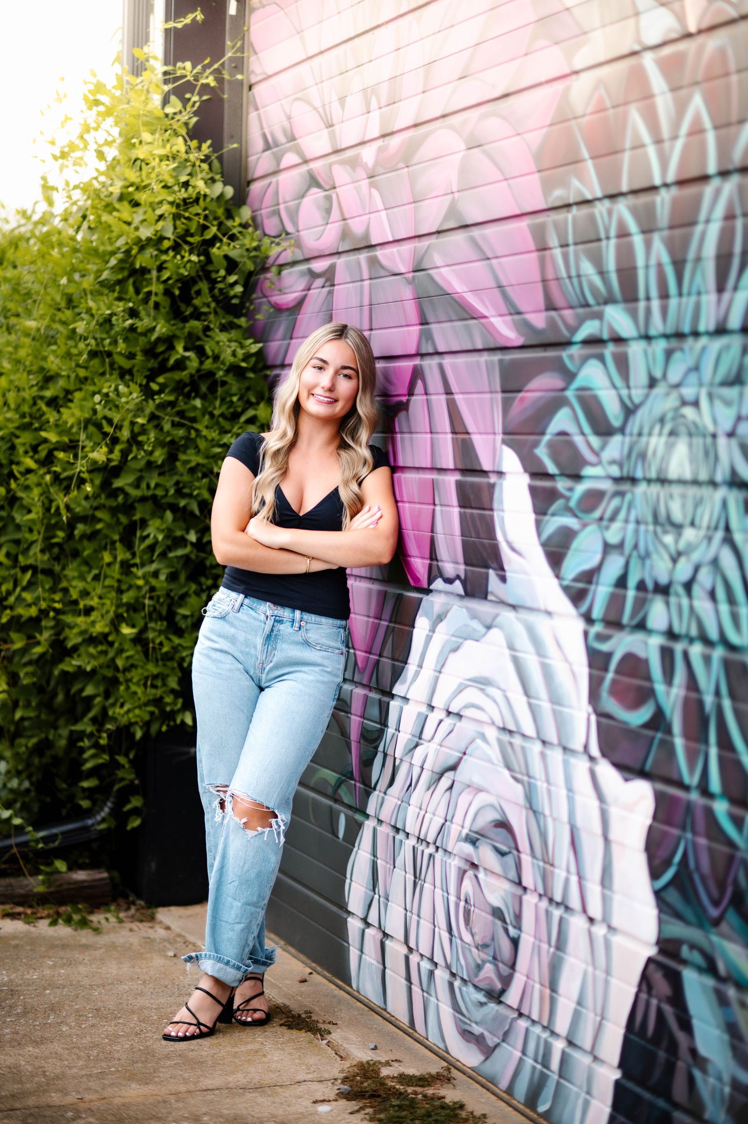 Urban photography session featuring a colorful graffiti wall with pink and blue tones.