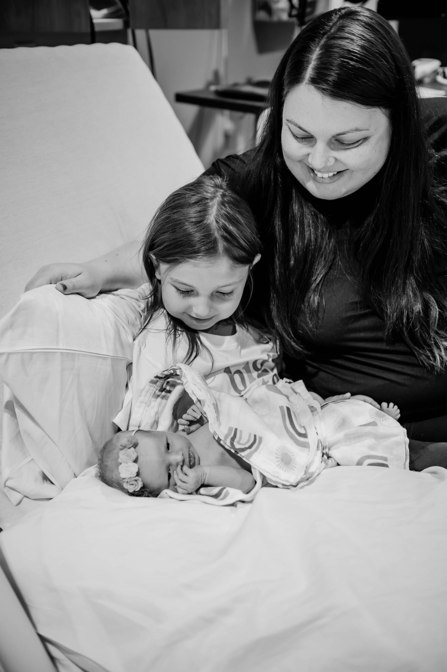 Intimate black and white photo of family members sharing a quiet moment together.