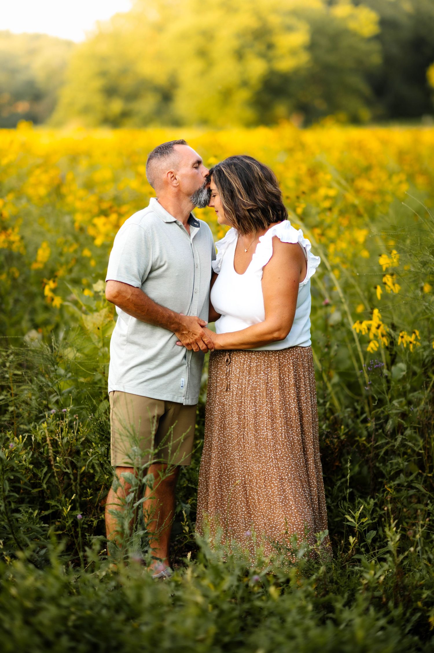 Intimate moments shared between people in a wildflower meadow during sunset.