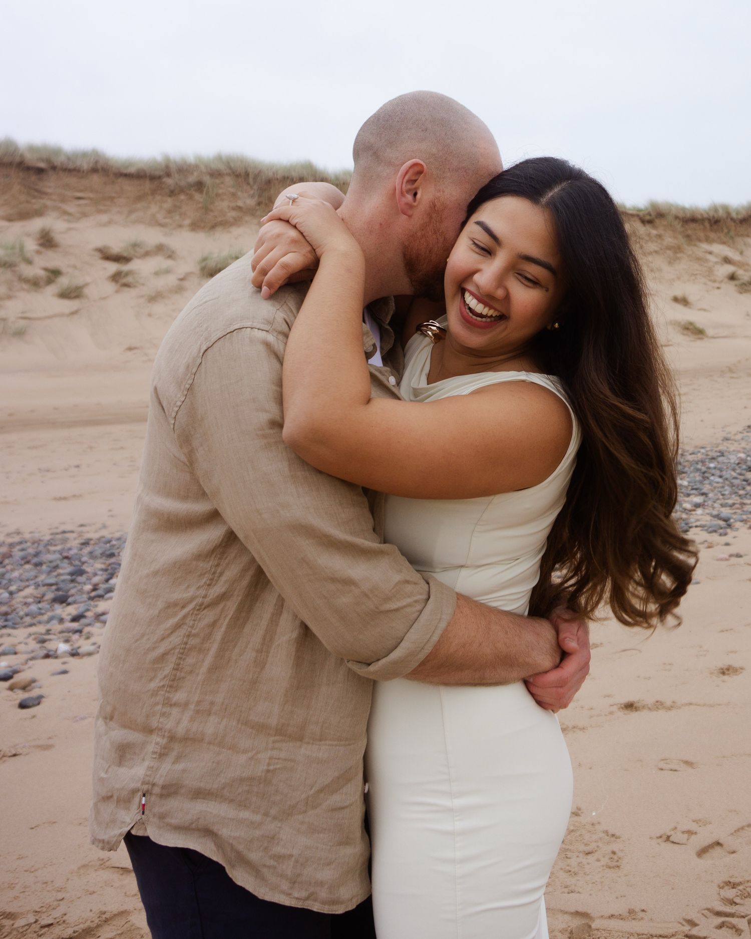 couple embracing during their photo session at the beach