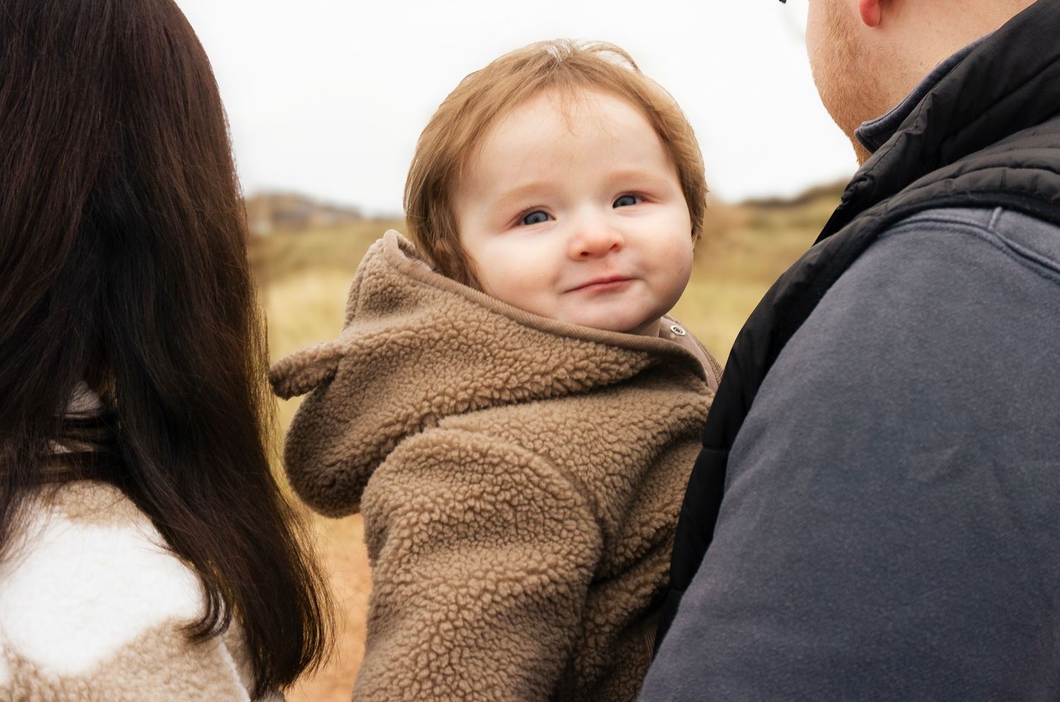 Baby smiling during a warm, natural lifestyle photoshoot