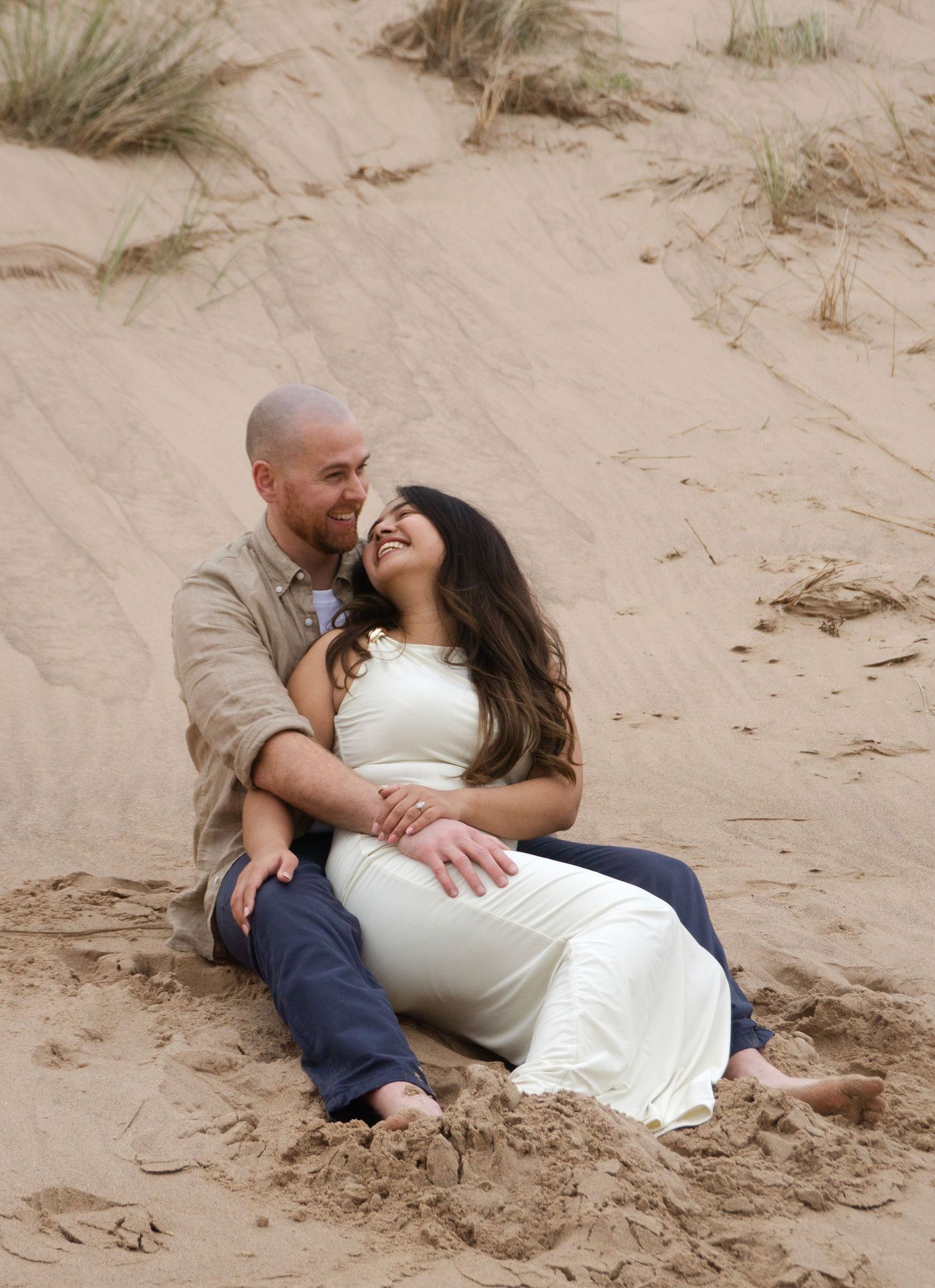 couple cuddlng during their photo session at the beach