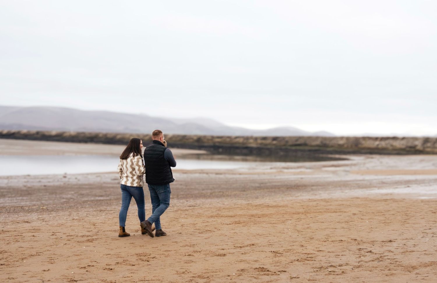 happy family walking on the beach during their  photo session